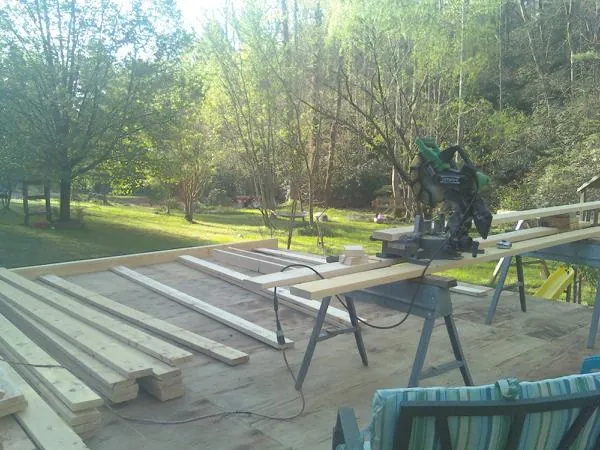 Miter saw and framing lumber on a deck under construction in Vienna